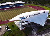 PTFI financed and built the Mimika Sports Complex, which includes an open-air stadium, indoor stadium, dormitory for athletes and coaches, and other supporting facilities. In a practice session, a sprinter breaks out of the blocks at the Mimika Sports Complex, one of four Papuan sites to host the 37 events of the 20th Indonesian National Games.