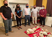 From left, Michael Tharby, Senior Geologist-Safford, and Tanayia White, Lead Native American Affairs Specialist-Safford, are joined by representatives of the San Carlos Apache Tribe during the presentation of turquoise. 