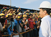 Construction workers greet Indonesian President Joko Widodo during a recent tour of the Manyar smelter and Manyar Maju refinery under construction in Gresik, East Java.