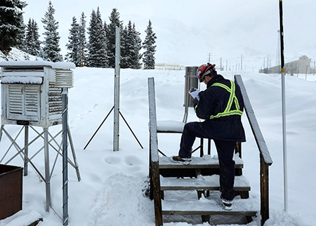 Robert Aumer, Mine Water Technician I-Climax, records recent snowfall at the mine’s weather observation station.