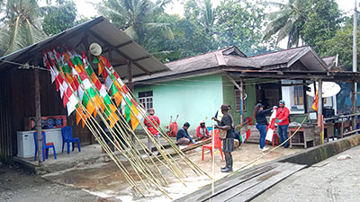 Village youth installed colorful flags to decorate Ayuka village streets in celebration of Indonesia’s 80th Independence Day. .